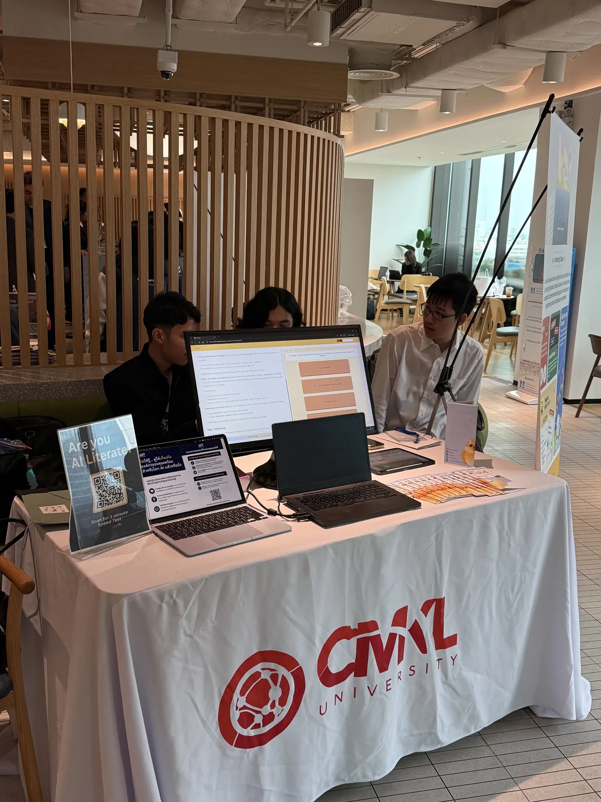 Canarie team members at the booth with the platform on screen